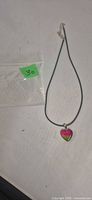 Necklace laid out with pendant and bag showing lot number