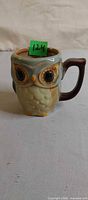 Front view of owl mug with item tag