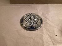 Top view of glass paperweight showing lace pattern