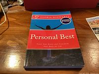 Front cover showing title, author, signed sticker