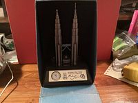 Twin Towers model inside open presentation box showing clock and plaque