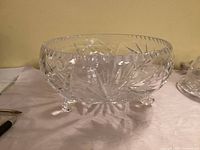 Oblique view of crystal bowl showing pinwheel cuts and three feet