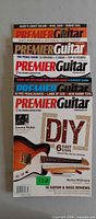 Stack of five Premier Guitar magazines, front issue shows DIY cover