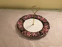 Top view showing floral pattern, handle, rim and overall condition