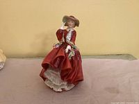Front view of Royal Doulton Top o’ the Hill figurine showing full dress and pose
