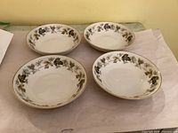 Four matching cereal bowls displayed top view