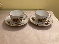 Two Royal Worcester Evesham cups on saucers