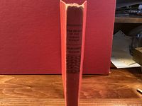 Spine view showing title and author on red cloth