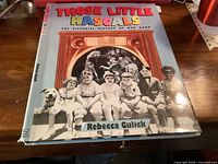 Front cover of hardcover book with title and cast photo