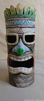 front view of carved wood Tiki mask sculpture