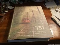 Front of dust-jacketed hardcover volume on desk