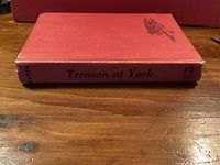 Spine and top board of red cloth hardcover with title Treason at York and author’s name visible