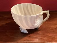 Cup side view showing shell form and handle