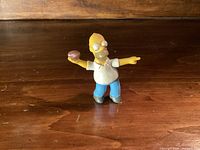 Front view of Homer Simpson figure holding football