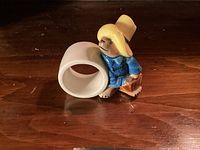 Front view of ceramic napkin ring and Paddington Bear figurine