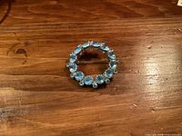 front view of brooch showing blue rhinestones