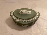 Lid in place showing chariot relief and laurel border