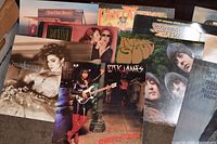 Front view showing eight of the vinyl album covers including Madonna, Rick James and others