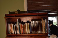 Open bookcase with assorted books and Time-Life Old West set