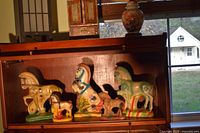 Shelf showing five chalkware horse figurines