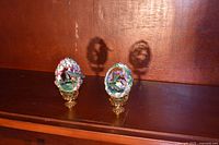 Two Fabergé hummingbird eggs on stands, front view