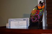 Porcelain cat-shaped plate on stand with certificate visible