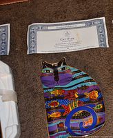 Plate with certificate on carpet, styrofoam packaging partially visible