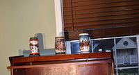 Three Budweiser holiday steins on shelf
