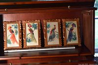 Front view of all four framed feather art bird pictures displayed together