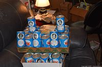 Tray of stacked blue RC Cola cans with athlete portraits visible