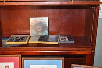 Group of six reel tapes on shelf