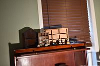 Overall shot showing three wooden shadow boxes with figurines in front