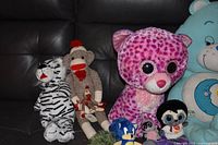 Front view showing several plush toys on couch