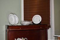 Stack of Grosgrain bowls on furniture, some wrapped, shows quantity