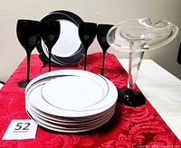 Overview of all items: five plates, four black wine glasses, flared glass vase