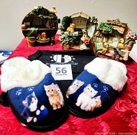 Front view showing three wall plates, kitten figurines and slippers