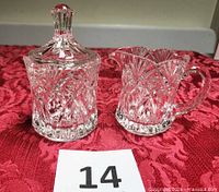 Creamer and lidded sugar bowl standing upright