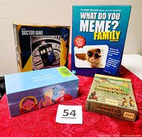 Group shot of all four boxed games with lot tag