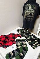 All four clothing items displayed together on table