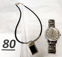 Watch and necklace side by side for scale and completeness