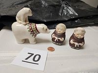 All four ceramic shakers with scale penny