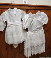 Front view of both dresses on hangers