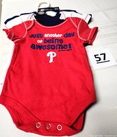 Front view red bodysuit with text graphic and Phillies logo