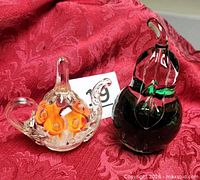 Both glass paperweights side by side