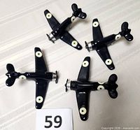 Four ceramic Spitfire models arranged on table with lot number
