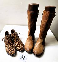 Both pairs of boots standing side by side