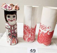 Front view of Susan Paley vase and two red peacock vases
