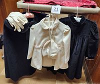 Group shot: black cape, black dress, cream coat, cream bonnet, cream gloves