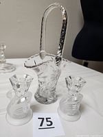 Basket vase and two swan candle holders grouped on table