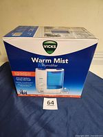 Front of sealed Vicks Warm Mist Humidifier box showing product image and branding
